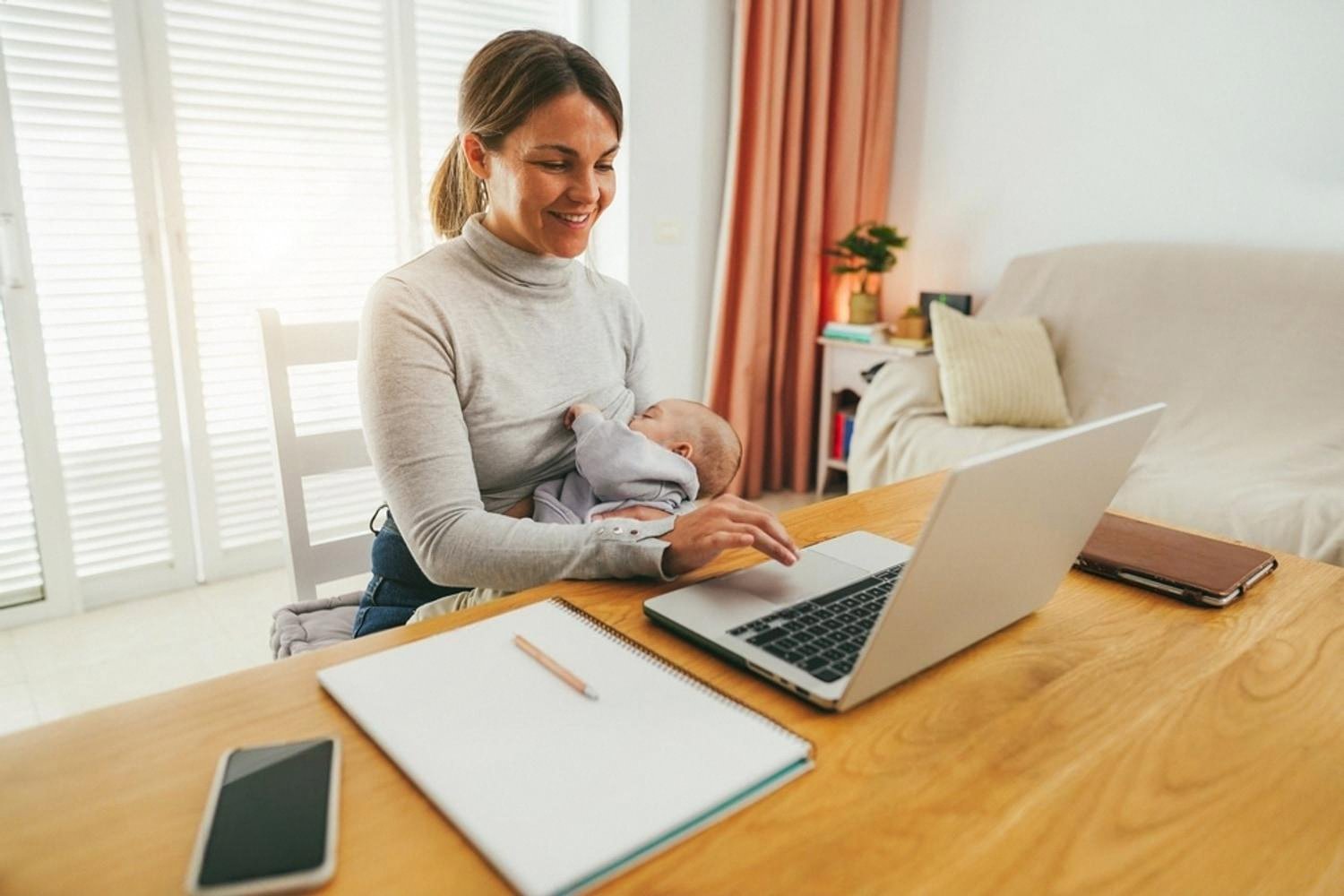 Woman working from home in the UAE registering a .ae domain on a laptop