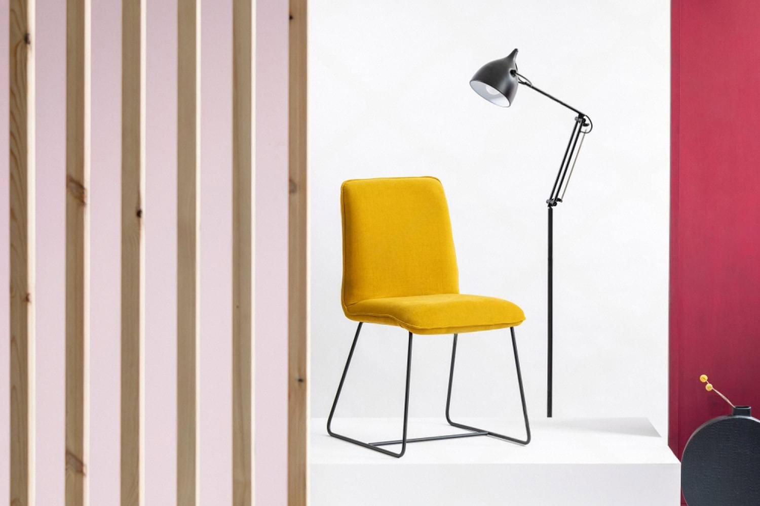 Yellow designer chair and floor lamp staged for a furniture rental listing in the UAE
